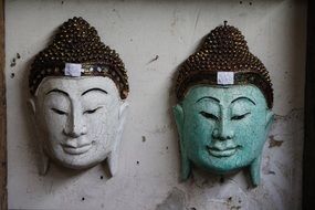 two decorations in the form of a buddha head