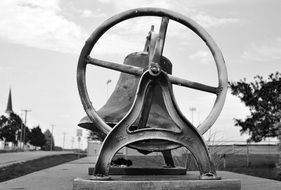 black and white photo of an antique church bell