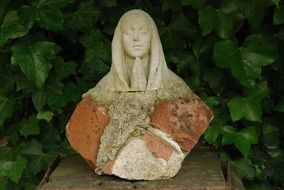 Religious statue near the green leaves