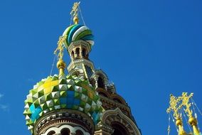 Golden crosses on the colorful domes of the church in St. Petersburg