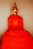 statue of buddha in red fabric