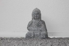 small buddha figurine on the carpet