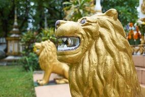 statues of Golden lions at the Buddhist temple