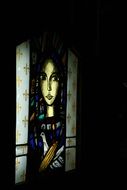 image of a saint on stained glass