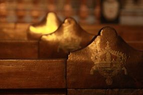 crown, painting on back of bench in church