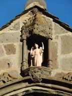 angel, Statue on facade at top of gothic Church, france, Auverge