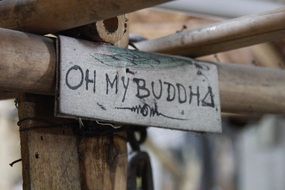 wooden sign with the inscription buddha