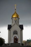 orthodox Church with Golden Dome at dark clouds, Russia