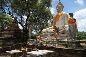 huge buddha at temple complex in thailand on a sunny day