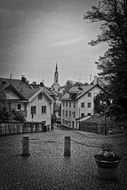 wooden spiers on the church behind the buildings