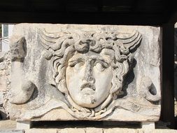 bas-relief with a face in a temple in the city of didyma