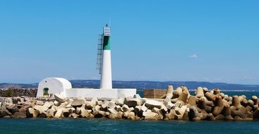 distant view of a white lighthouse on a sunny day