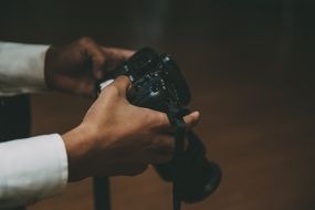 man holds digital camera in hands