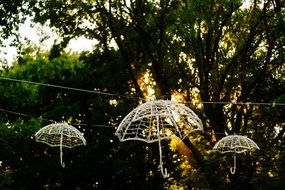 white umbrellas on a light chain