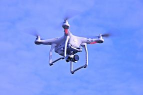 white drone in flight in the sky