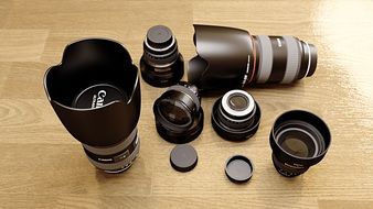 a variety of Canon lenses on a wooden surface