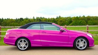 side view of a luxurious pink Mercedes