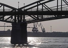 bridge over the Danube river against the background of port cranes in Slovakia