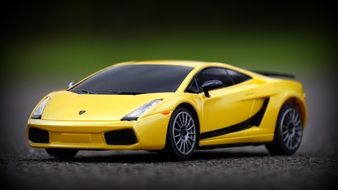 yellow lamborghini as a model on the pavement closeup