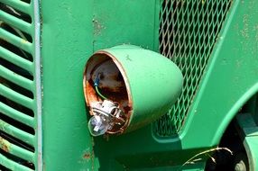 broken headlight of an old tractor close-up