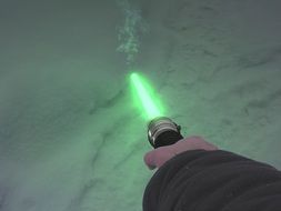 man holds a lightsaber in his hand