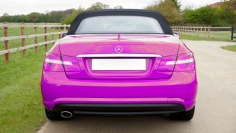 rear view of a luxurious pink Mercedes on a sunny day