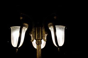 street lamp with three lamps in the dark