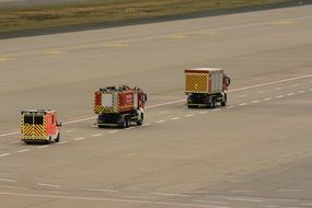 three fire engines on the runway