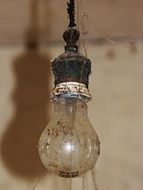 Old dirty incandescent bulb with the shadow