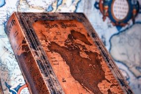vintage book with old earth map cover