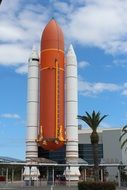 space shuttle on a clear day with white clouds