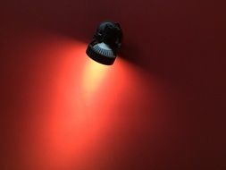 black lamp on the red wall