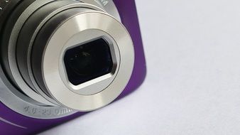 purple camera lens on a white table