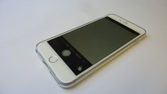 touchscreen iphone on white surface