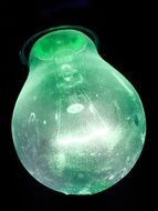 light bulb with green glass on a black background