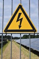 high voltage sign on the fence