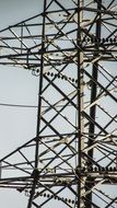high voltage support pylon and cloudy sky