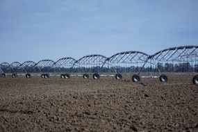 irrigators on an agricultural field on a sunny day