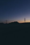 remote view of power lines at sunset