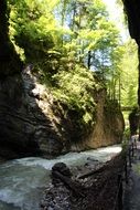 landscape view of a stormy river in Partnachklamm gorge on a sunny day