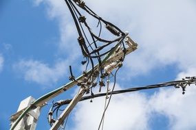 high mast with electric wires and clouds