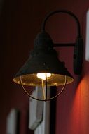 lamp hanging on a red wall