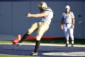 american football player and referee on the field