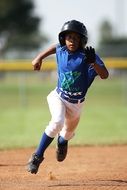 minor league baseball player runs to base