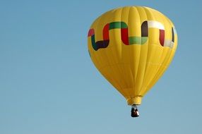 flying in a bright yellow hot air balloon