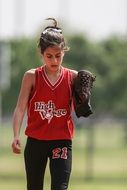 girl playing softball on the field