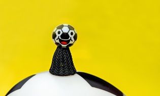 soccer jumper stands on a soccer ball