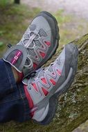 Feet with the shoes on the wood