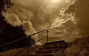 photo of a stone staircase and railings against the background of the evening cloudy sky