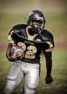 portrait of soccer player carries ball on field in american football